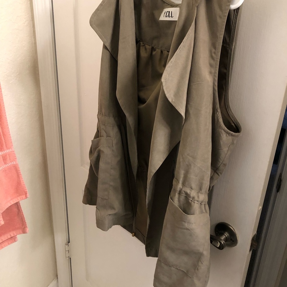 Tan vest. Drawstring across the chest. Hood attached